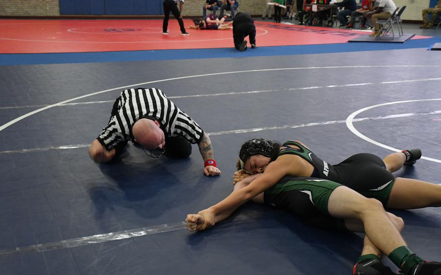 The referee goes to signal that AFNORTH's Rachele Reyes has pinned her opponent at 120 pounds Saturday, Dec. 3, 2022 at RAF Lakenheath, England