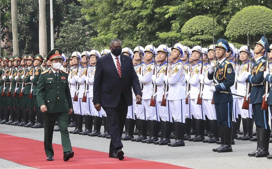 U.S. Secretary of Defense Lloyd Austin with Vietnamese Defense Minister Phan Van Giang, left, inspects an honor guard in Hanoi, Vietnam, Thursday, July 29, 2021. 