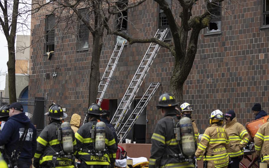 Ladders are seen erected beside the apartment building where a fire occurred in the Bronx on Sunday, Jan. 9, 2022, in New York.