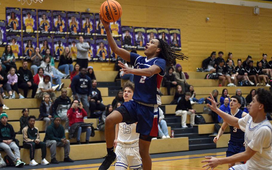 Aviano junior Andrew Walker drives to the bucket against Rota in pool-play action of the DODEA European Basketball Championships on Feb. 15, 2024, at Wiesbaden High School in Wiesbaden, Germany.