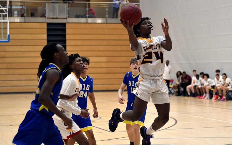 Baumholder sophomore Gregory Makubuya floats in the air as he goes for a layup during pool-play action of the DODEA European basketball championships against Sigonella on Feb. 14, 2024, at the Wiesbaden Sports and Fitness Center on Clay Kaserne in Wiesbaden, Germany.