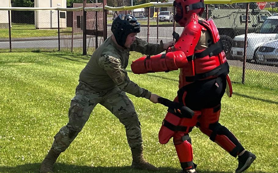 Senior Airman Conner Troy, left, of the 374th Security Forces Squadron fights a combative subject during a fire team challenge at Yokota Air Base, Japan, May 17, 2023. 