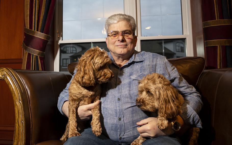 Larry Wexler sits for a portrait at his residence with his dogs Max and Maggie in Virginia Beach, Va., on Dec. 8, 2022. Wexler is the author of the children’s book “Forest of Dreams,” and an Iraqi war veteran. Max and Maggie inspired the subject of Wexler’s book.