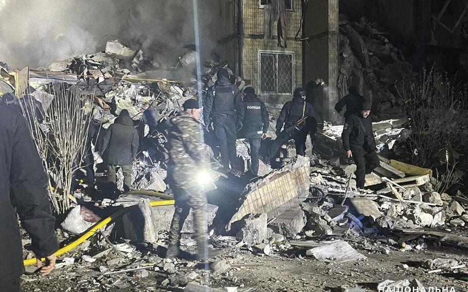 In this photo provided by the Ukrainian Police Press Office, emergency workers work on the site of a destroyed multi-store building after a Russian attack on residential neighborhood in Odesa, Ukraine, Saturday, March 2, 2024.