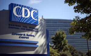 A large sign above the entrance to a building reads “CDC Centers for Disease Control and Prevention Edward R Roybal Campus.: