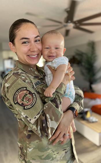 Space Force Capt. Charlene Kabuanseya, 747th Communications Squadron cyber defense flight commander, holds her 5-month-old child, Leo, in Honolulu, Hawaii, June 15, 2021. As a new nursing mother, Kabuanseya continued to provide breast milk during a 45-day temporary duty travel assignment and received reimbursement, making it one of the first instances for a service member receiving compensation for the expense of shipping breast milk.