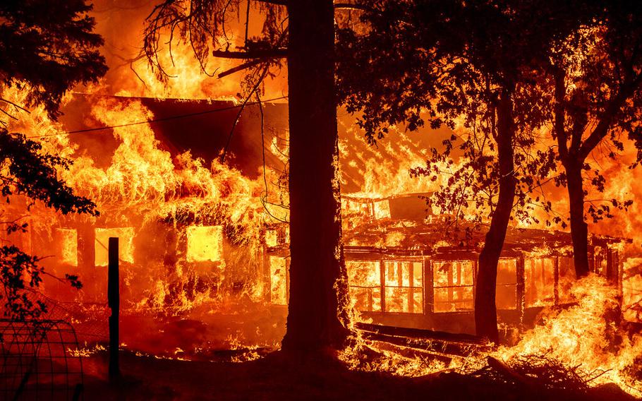 Flames from the Dixie Fire consume a home in the Indian Falls community of Plumas County, Calif., Saturday, July 24, 2021. The fire destroyed multiple residences as it tore through the area. 