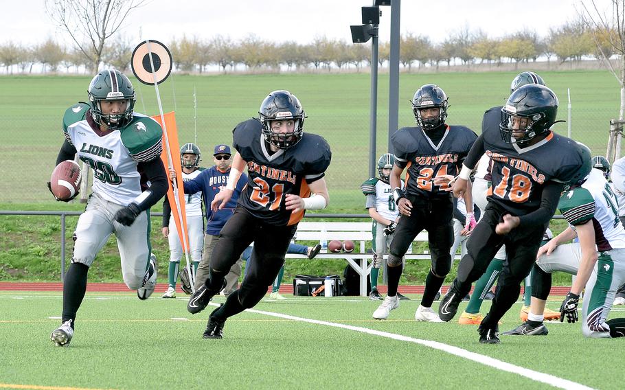 AFNORTH’s Connor Luminarias looks for running room as Spangdahlem’s Michael Landers and Cordrick Sago give chase during a DODEA-Europe Division III semifinal in Spangdahlem, Germany. 