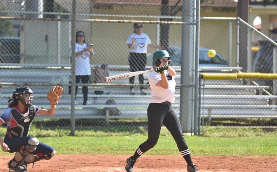 Naples’ Ann Gose takes a swing at a high pitch during the Wildcats’ 21-3 victory over Aviano in the first game of a doubleheader Saturday, April 13, 2024.