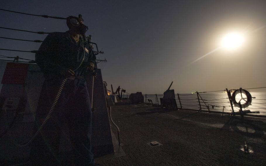 Seaman Aaron Henry monitors the horizon for surface and air contacts during watch onboard the guided missile destroyer USS Sterett in the Gulf of Oman in September 2020. A recent U.S. Government Accountability Office report says despite a 2017 Navy policy aimed at managing fatigue, the Navy has inconsistently implemented the policy and most officers are not getting adequate sleep.