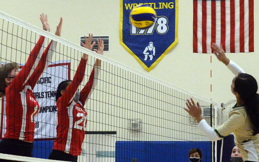 Robert D. Edgren's Annalise Tackney tries to hit through the double block of Nile C. Kinnick'sKathryn Withers and Jenia Viles during Saturday's Japan girls volleyball match. The Eagles won in straight sets, improving to 10-0 on the season without dropping a set.