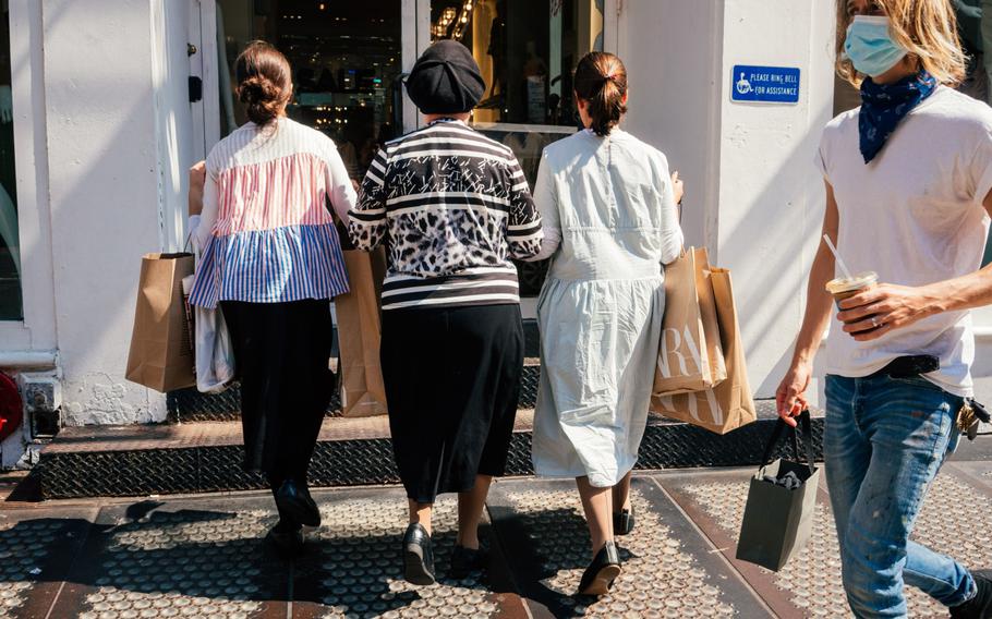 Shoppers enter a clothing store in the SoHo neighborhood of New York on Aug. 25, 2021.