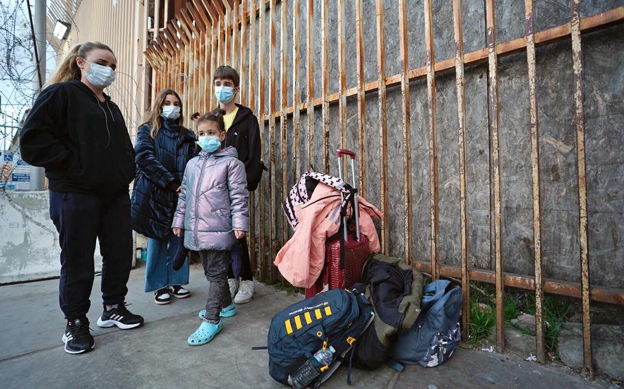 A Ukrainian family waits by the pedestrian entrance at the San Ysidro Port of Entry on Wednesday, March 8. 2022, after U.S. officials turned the four away. Sofiia, 34, and her three children, ages 14, 12 and 6, are seeking asylum after Russia invaded their country. 