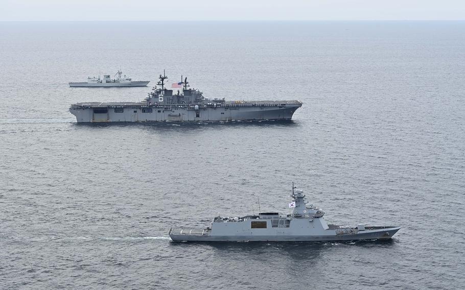 The amphibious assault ship USS America, center, the South Korean guided-missile frigate ROKS Seoul, bottom, and the Canadian frigate HMCS Vancouver train together in the Yellow Sea, Thursday, Sept. 14, 2023. 