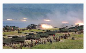 This undated photo released by North Korea's official Korean Central News Agency (KCNA) on Aug. 26, 2017, shows rockets being launched by Korean People's Army (KPA) personnel during a target strike exercise at an undisclosed location in North Korea. (STR/AFP via Getty Images/TNS)