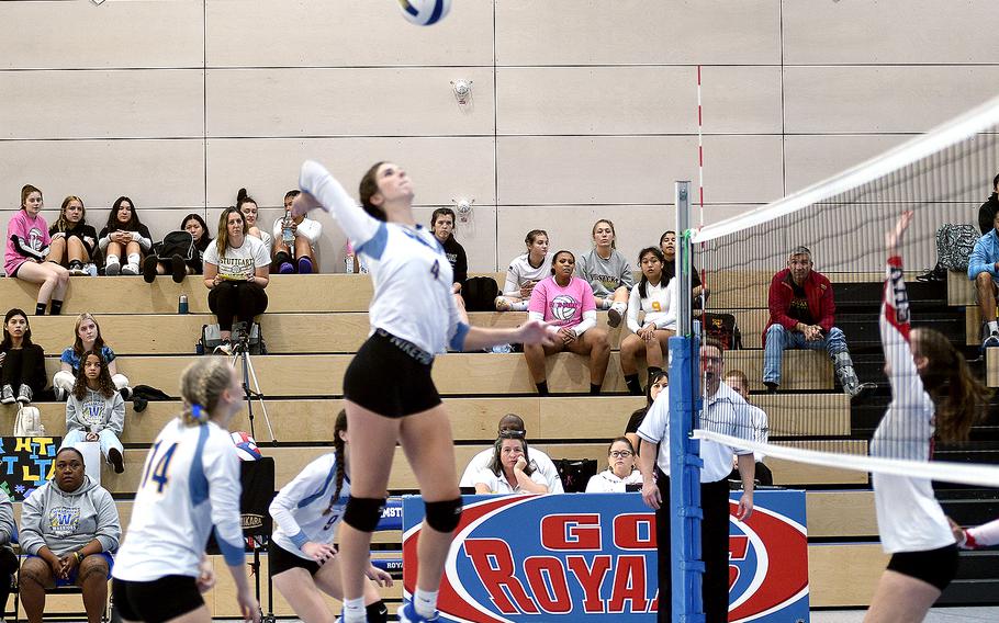 Wiesbaden's Lyndsey Urick, center, prepares to spike the ball as teammate Elizabeth Troxel watches and Kaiserslautern's Mariska Campbell gets ready to block during DODEA European volleyball championship pool-play action Friday at Ramstein High School on Ramstein Air Base, Germany.