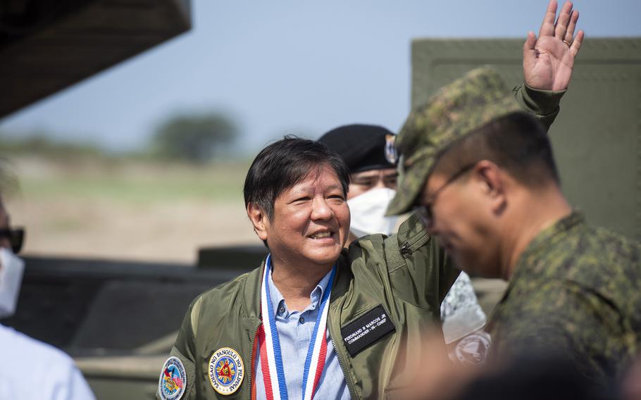 Philippines President Ferdinand Marcos Jr. waves to reporters after touring a M142 High Mobility Artillery Rocket System, or HIMARS, while attending a Balikatan live-fire drill at Naval Station Leovigildo Gantioqui in San Antonio, Philippines, Wednesday, April 26, 2023. 