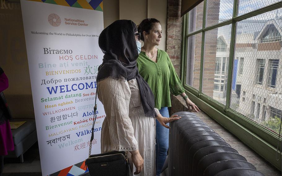 Karimi, 40, foreground, was evacuated from Afghanistan and resettled in Philadelphia with her her husband and 8-year-old son. Her 18-year-old son became separated from the family and was left behind. He is now in Taliban custody. Beside Karimi stands Gwen Soffer, the manager of wellness at Nationalities Service Center in Philadelphia, where this photo was taken. Karimi, who is being identified only by her last name, wears glasses to help shield her identity. 