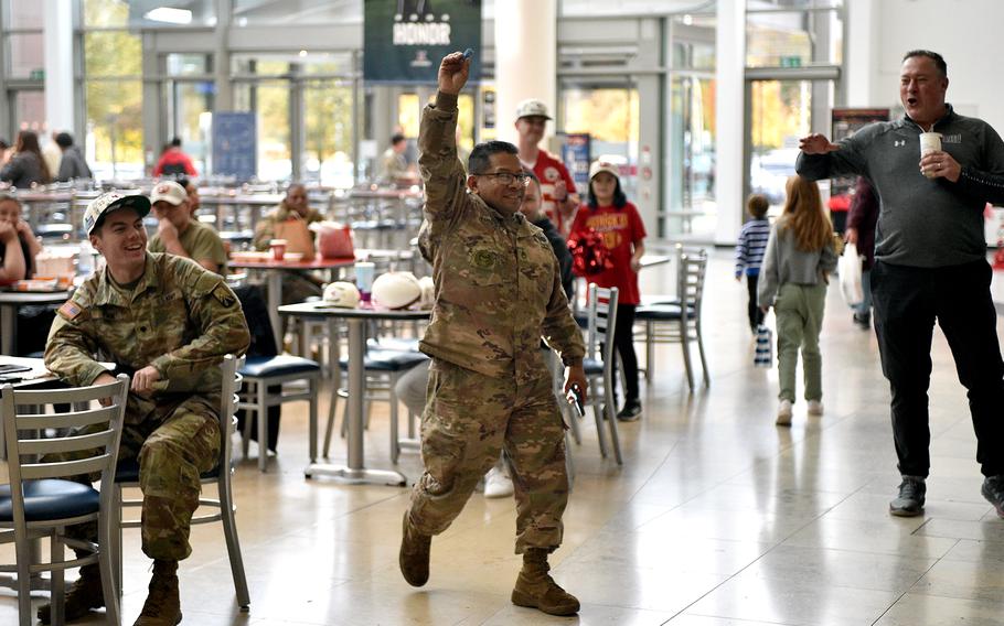 Staff Sgt. Hector Hernandez of the 66th Transportation Company holds up the winning raffle ticket during an event with the Kansas City Chiefs on Nov. 2, 2023, at Ramstein Air Base, Germany. Hernandez received two tickets to the Chiefs' game against the Miami Dolphins in Frankfurt. It was the second regular season NFL game in Germany and the first in Frankfurt.