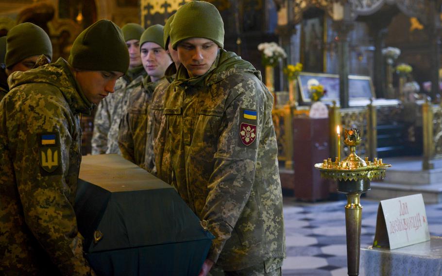 Ukrainian troops carry the casket of a Georgian soldier out of St. Volodymyr’s Cathedral in Kyiv, Ukraine, at the end of funeral services Nov. 1, 2022. The soldier, Gurgen Gagnidze, had been a foreign volunteer from the country of Georgia serving in Ukraine’s 25th Airborne Brigade.