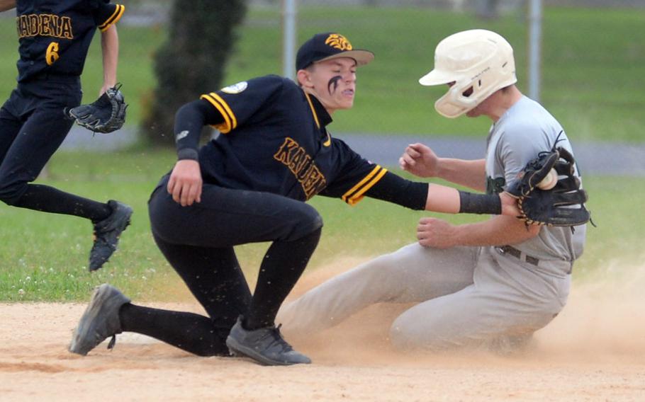 Kubasaski's Lukas Gaines slides safely into second base ahead of the tag by Kadena shortstop Levi Galle during Monday's DODEA-Okinawa baseball game. The Dragons won 10-2.