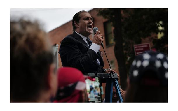 State Senator Andrew Lanza speaks to residents as they gather to protest outside of a closed Catholic school-turned-migrant shelter on Staten Island on Aug. 28, 2023, in New York City.