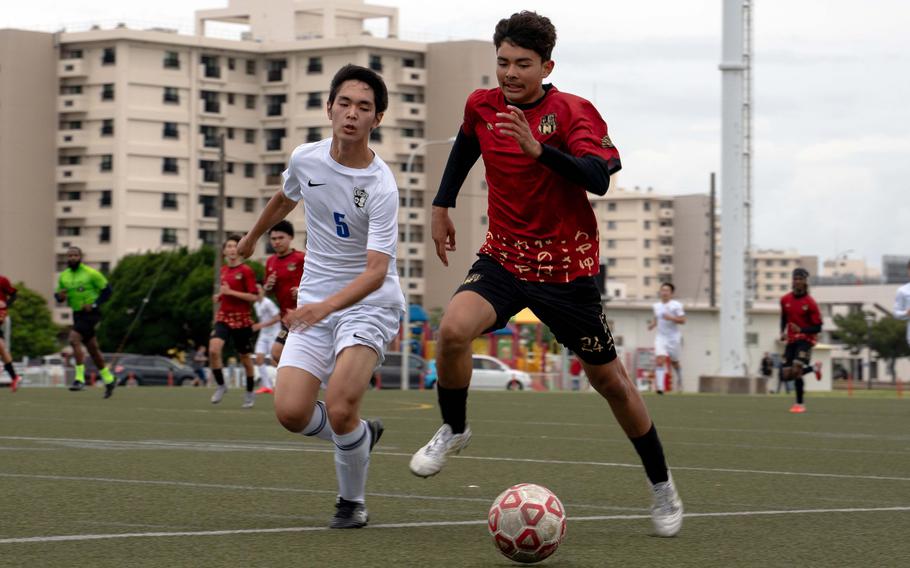Juvenal Jimenez and Michael Domondon chase the ball.