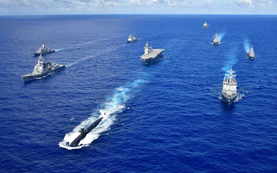 Warships from the navies of Australia, South Korea, Japan and the United States sail in formation during an exercise in the Pacific Ocean in 2020. Defense spending alone is an incomplete measure of military fitness, according to a recent Rand Corp. study, which said the Pentagon needs a new method for measuring whether countries in Europe and Asia are carrying their fair share of the security burden.