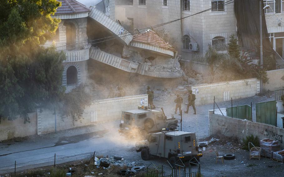 An Israeli army unit inspects the house of the Palestinian American Muntasser Shalaby following controlled explosions, in the West Bank village of Turmus Ayya, north of Ramallah, Thursday, July. 8, 2021. 