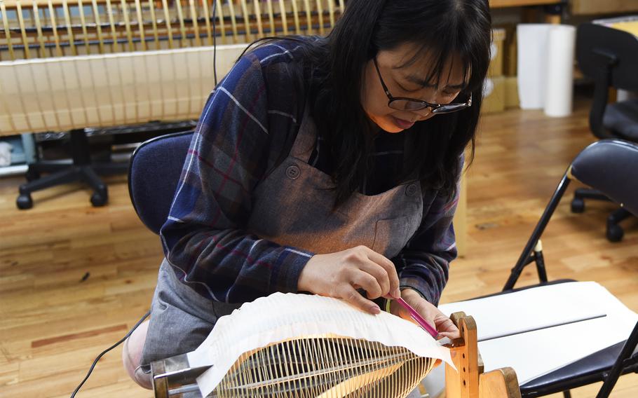 Shiho Abe makes a lantern at the Suzuki Mohei Shoten  in Mito, Ibaraki prefecture, Japan, on Nov. 9, 2023. 