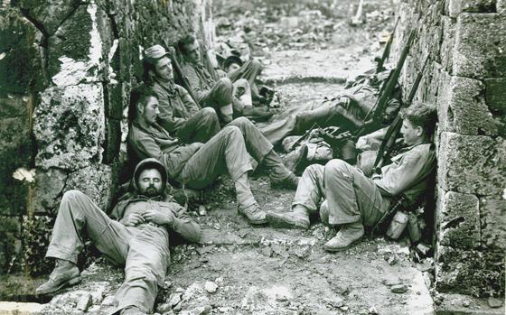 Marines of a Sixth Division mortar crew rest after a hard night of fighting for the capital city of Naha, during the Battle of Okinawa, Japan, in spring 1945.

