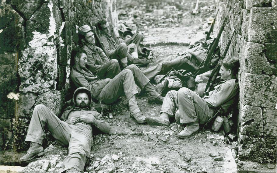 Marines of a Sixth Division mortar crew snatch 40 winks after a hard night of fighting for the capital city of Naha.