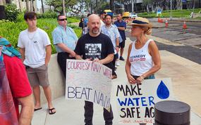 Supporters of plaintiffs suing the U.S. government over injuries they say they sustained from jet-fuel contamination in Hawaii wait outside the federal courthouse in Honolulu, April 29, 2024.