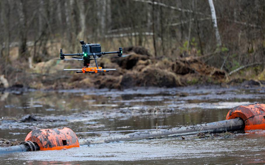 A drone hovers above the water.