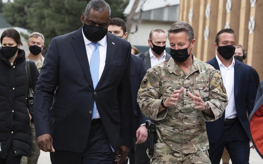 Secretary of Defense Lloyd J. Austin III walks with the commander of NATO’s Resolute Support Mission and U.S. Forces – Afghanistan, Army Gen. Scott Miller, at Resolute Support Headquarters, Kabul, Afghanistan, March 21, 2021.