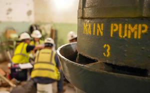 Contractors sitting near a pump.