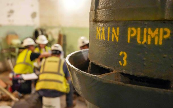 Contractors sitting near a pump.
