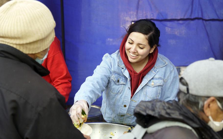 Staff Sgt. Angel Ramirez, of Yokota Air Base, Japan, serves food during a homeless outreach project at Ueno Park in Tokyo, March 15, 2024.