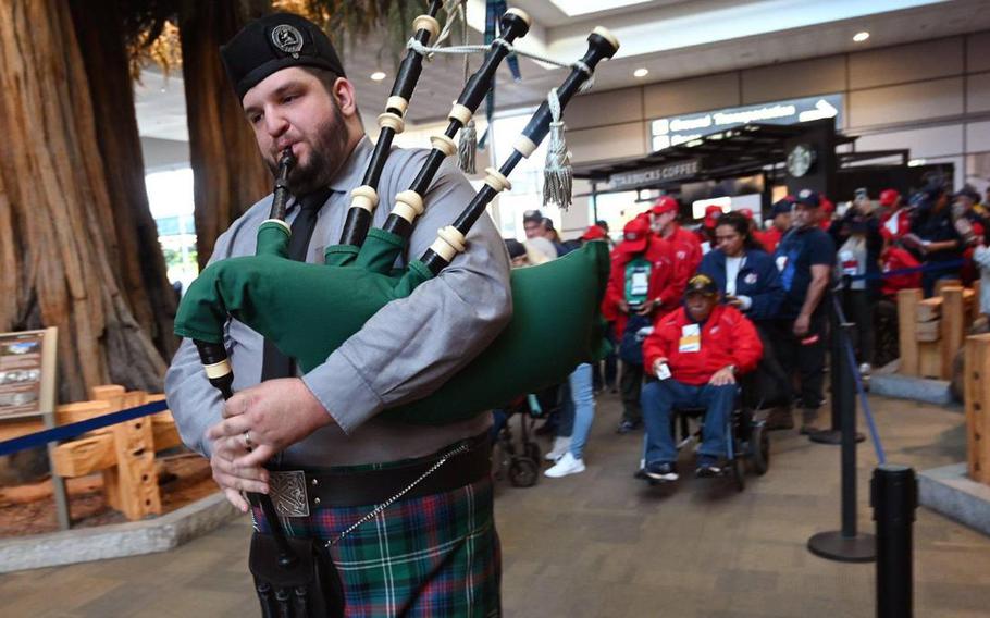 A bagpiper leads 63 veterans in a procession as they board their flight for the Central Valley Honor Flight #21 Monday morning, May 16, 2022, at Fresno Yosemite International Airport.