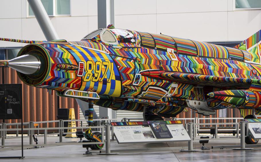 A MiG-21 fighter jet covered in colorful glass beads.