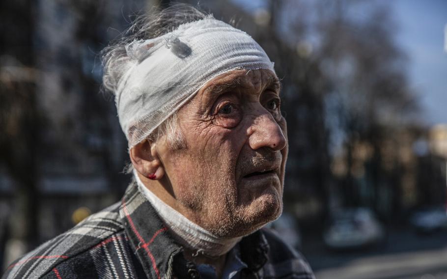 A wounded man with his head bandaged after Russian strikes hit the Kurenivka area of Kyiv on March 14, 2022. 