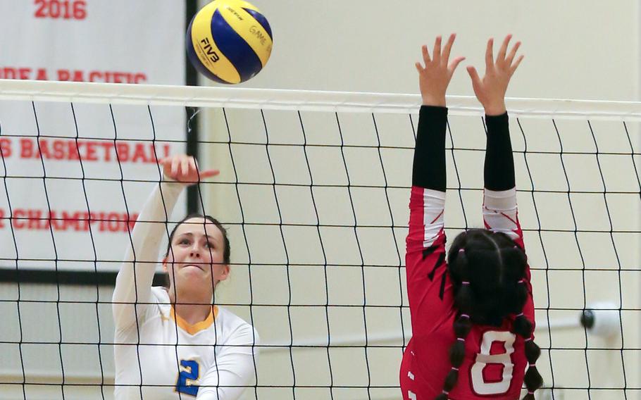 Yokota’s Malia Hutchins (2), hitting against E.J. King’s Sarah Goleman,  was named the tournament’s Most Valuable Player. It was her serving that helped turn the Far East Division II girls volleyball tournament final around.