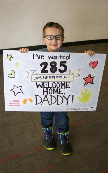Wyatt Cade, 5, holds a sign for his dad, Maj. Cody Cade, as he waits to welcome him home Jan. 13, 2024, at Eppley Airfield in Omaha, Neb.