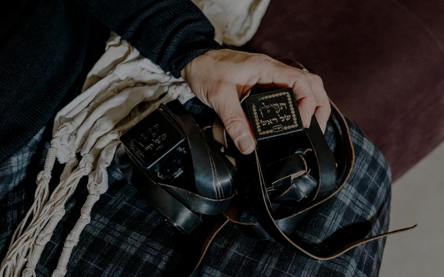 Binyamin’s mother holds his tefillin. The American-Israeli dual citizen was killed in November. 