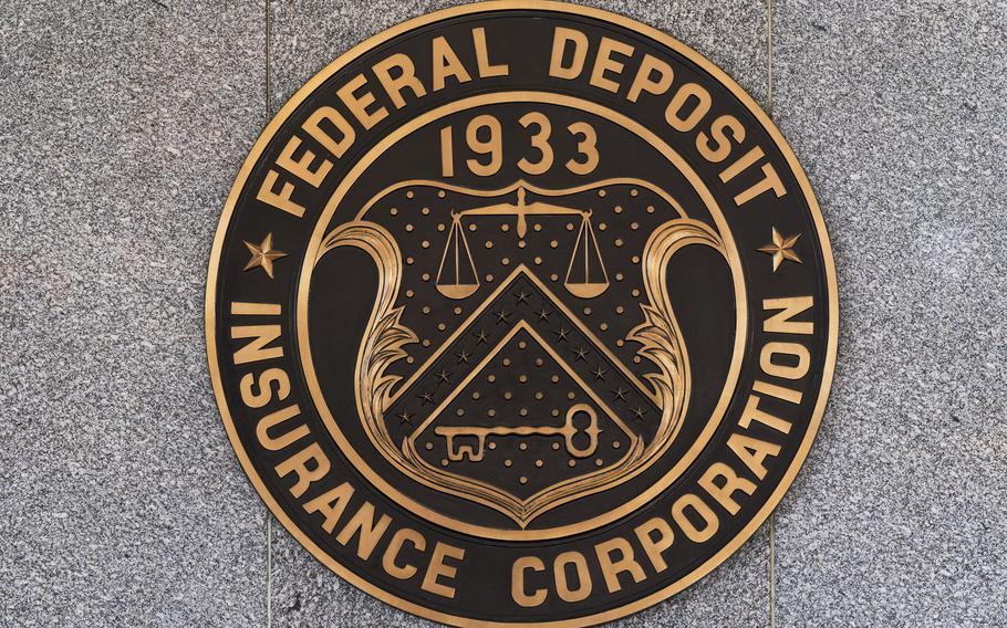 The Federal Deposit Insurance Corporation (FDIC) seal is shown outside its headquarters, Tuesday, March 14, 2023. Depositors withdrew savings, and investors broadly sold off bank shares as the federal government raced to reassure Americans that the banking system is secure following two bank failures.