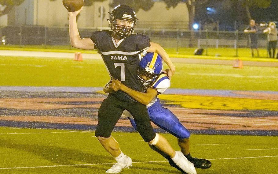 Zama quarterback Dominic Peruccio tries to pass as a Yokota’s Kamaury Freeman tries to wrap him up.