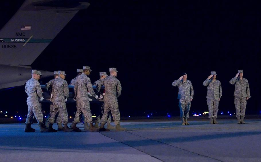 A U.S. Air Force carry team transfers the remains of Air Force Maj. Randy Voas at Dover Air Force Base, Del., on April 10, 2010.  