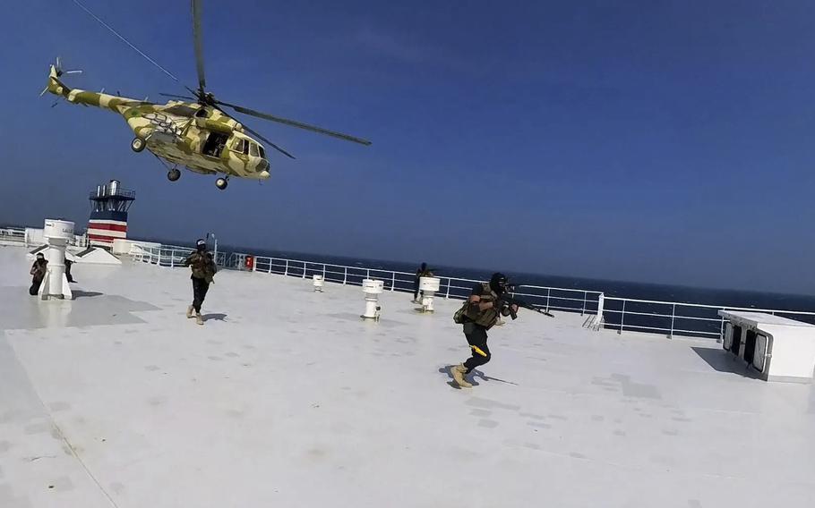 This photo released by the Houthi Media Center shows Houthi forces boarding the cargo ship Galaxy Leader on Sunday, Nov. 19, 2023. Yemen's Houthis have seized the ship in the Red Sea off the coast of Yemen after threatening to seize all vessels owned by Israeli companies. 