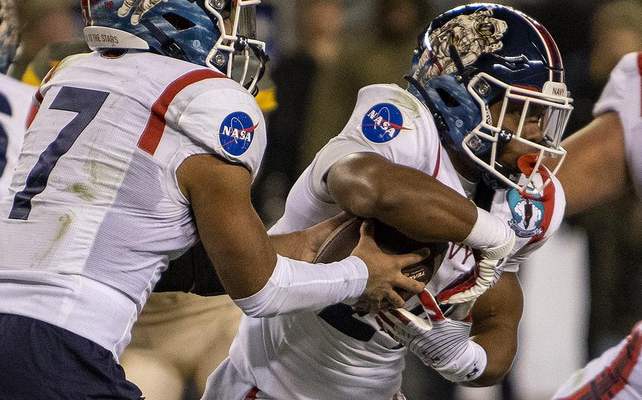 Navy QB Xavier Arline (7) fakes a handoff to slotback Maquel Haywood (24) during the 123rd Army-Navy football game played at Philadelphia’s Lincoln Financial Field on Saturday, Dec. 10, 2022. Army went on to beat Navy 20-17 in double overtime.