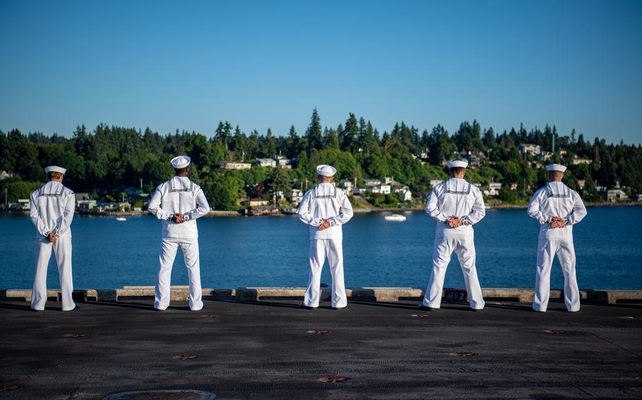 Sailors man the rails on the flight deck of the aircraft carrier USS Nimitz on its return to homeport.